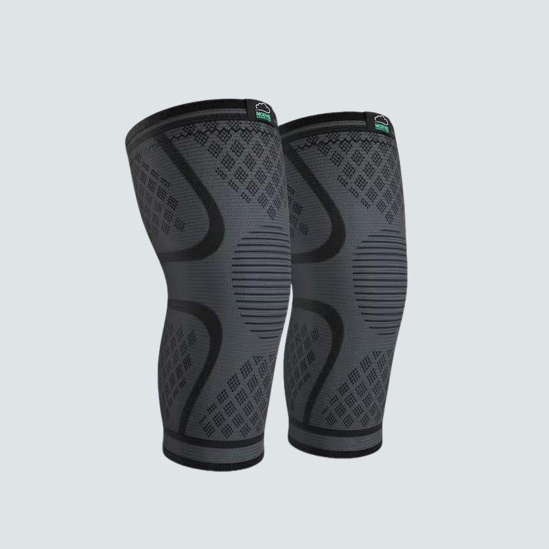 Pair of gray and black compression knee sleeves on a light gray background
