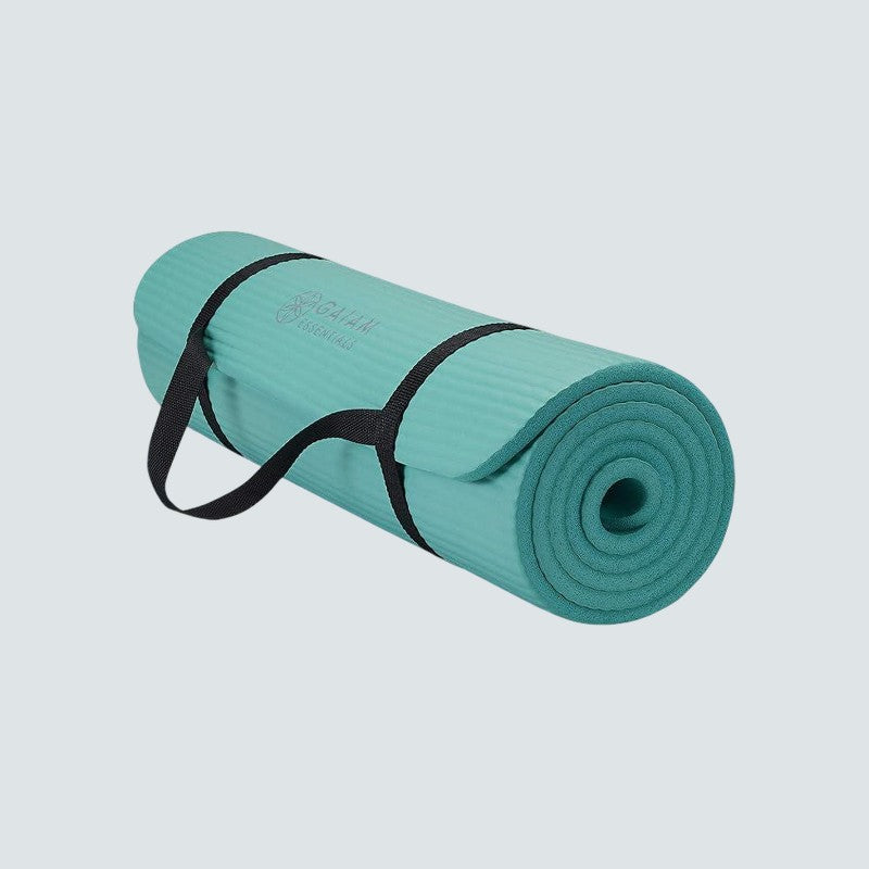 Teal yoga mat with a black strap on a light gray background