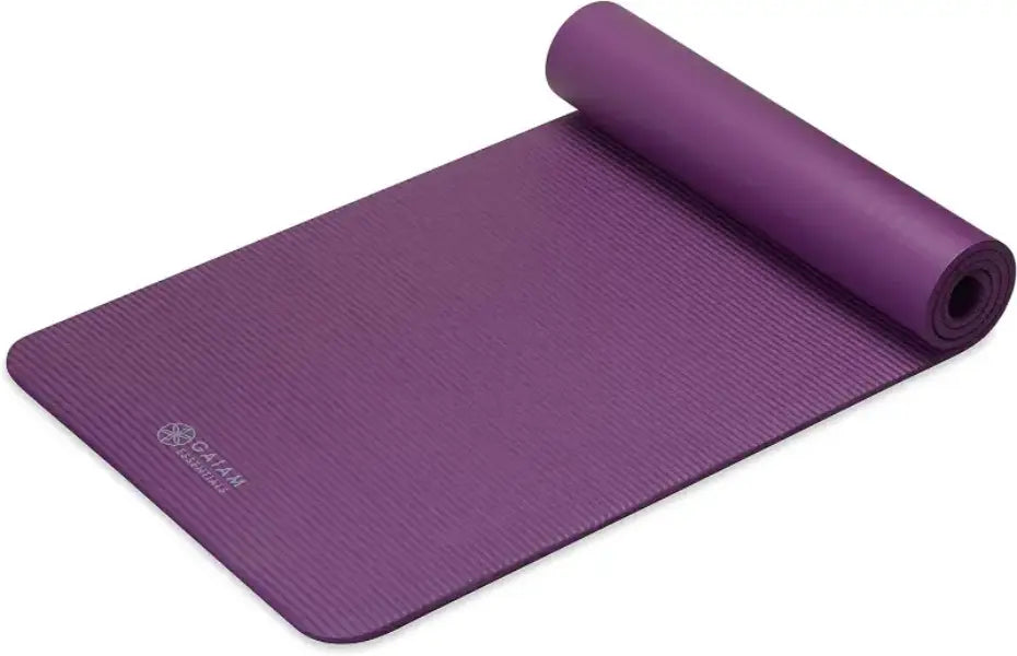Purple yoga mat with rolled-up end on a white background