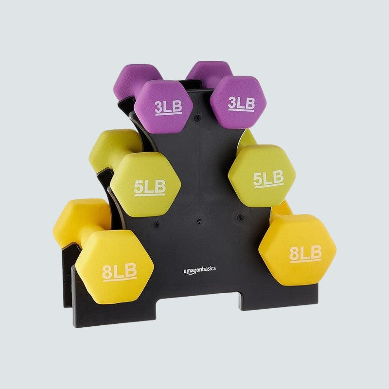 Set of dumbbells with purple and yellow weights on a gray background