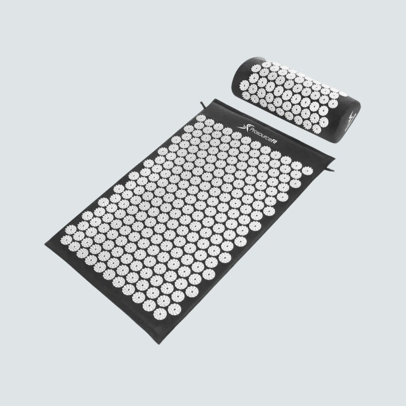 Acupressure mat and pillow set on a light gray background