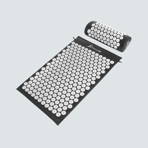 Acupressure mat and pillow set on a light gray background