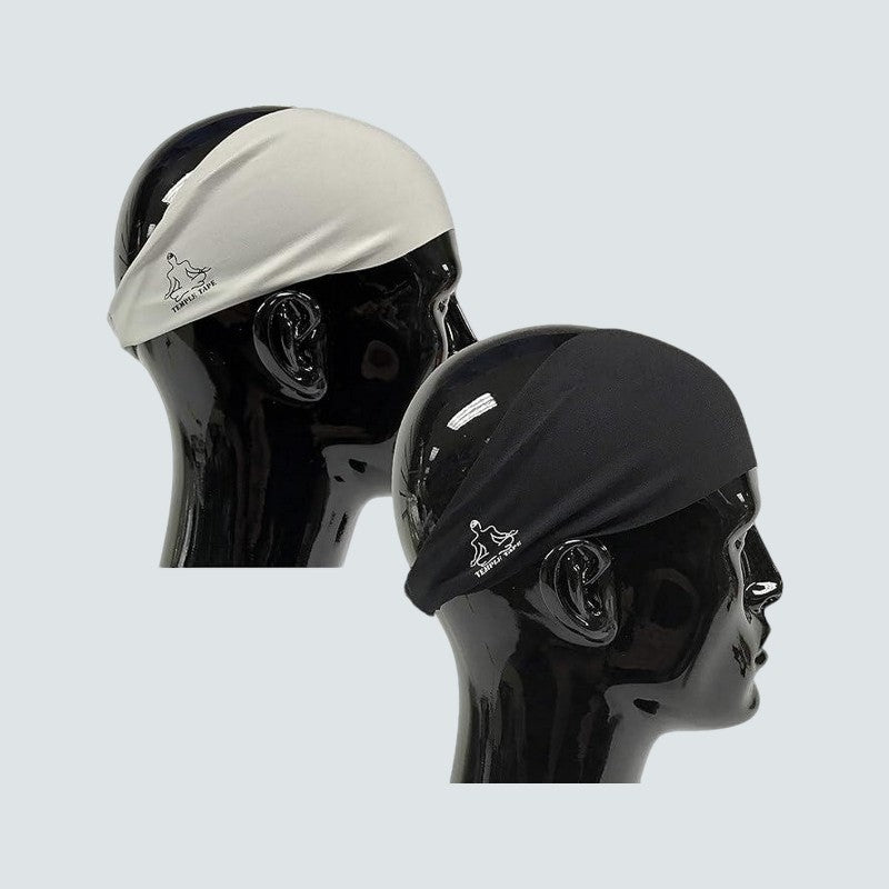 Two swim caps, one white and one black, on mannequin heads against a light gray background.