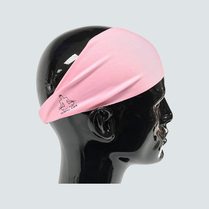 Pink headband on a black mannequin head against a light gray background