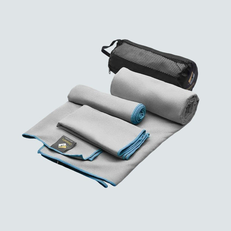 Gray cooling towel with blue accents and a black mesh storage bag on a light gray background