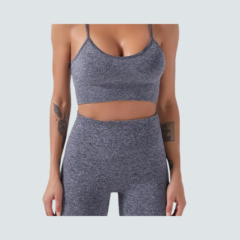 Person wearing a gray athletic outfit on a light gray background