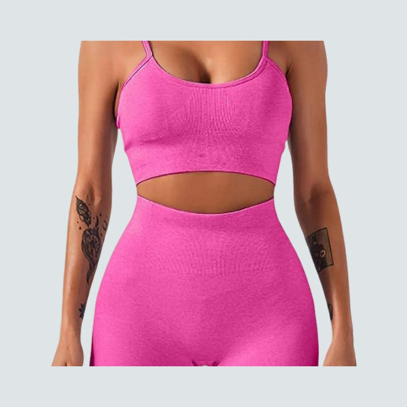 Person wearing a bright pink athletic outfit on a light gray background