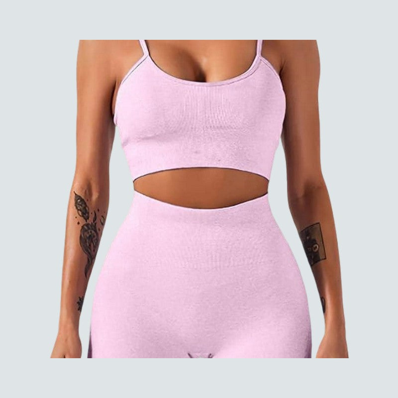 Person wearing a pink athletic outfit on a light gray background