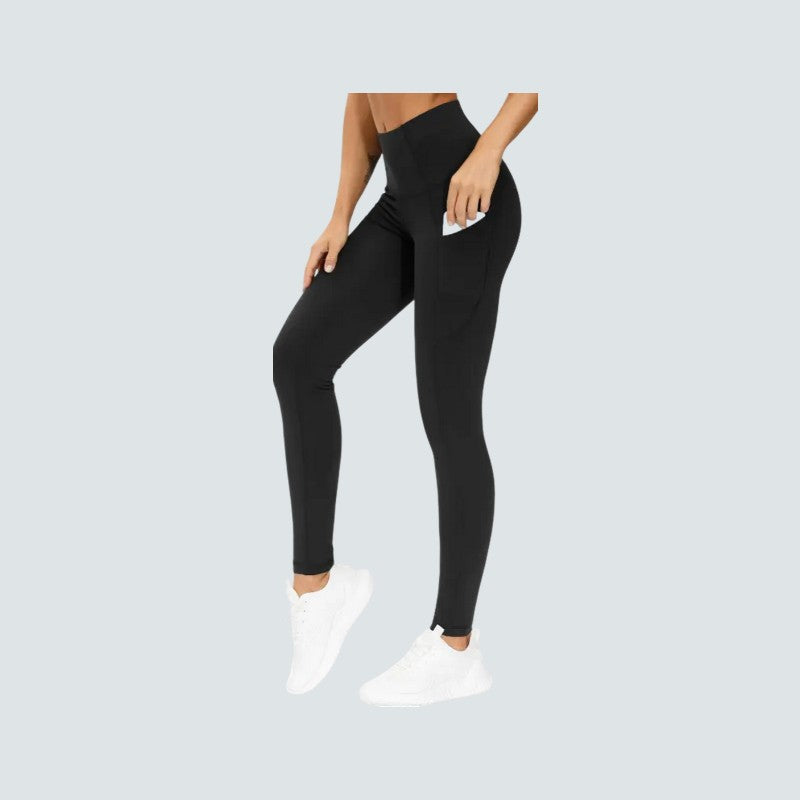 Person wearing black leggings on a light gray background