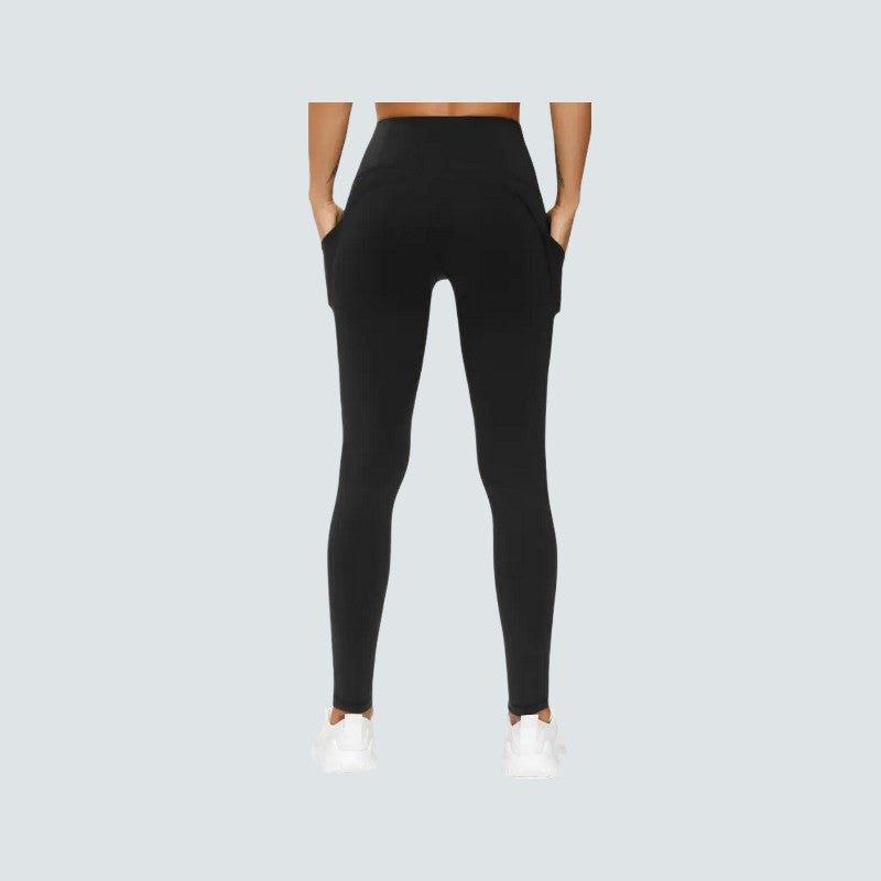 Person wearing black leggings on a light gray background